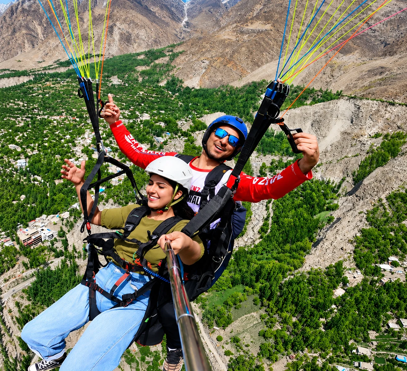 Tandem paragliding above a green mountain valley in Pakistan